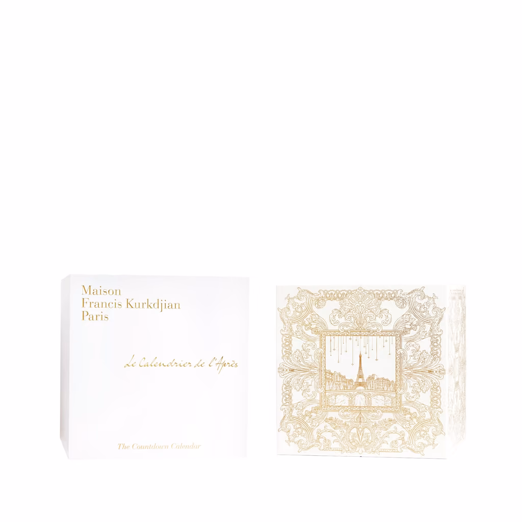 The white sleeve beside the box, its front printed in gold with a theatre facade