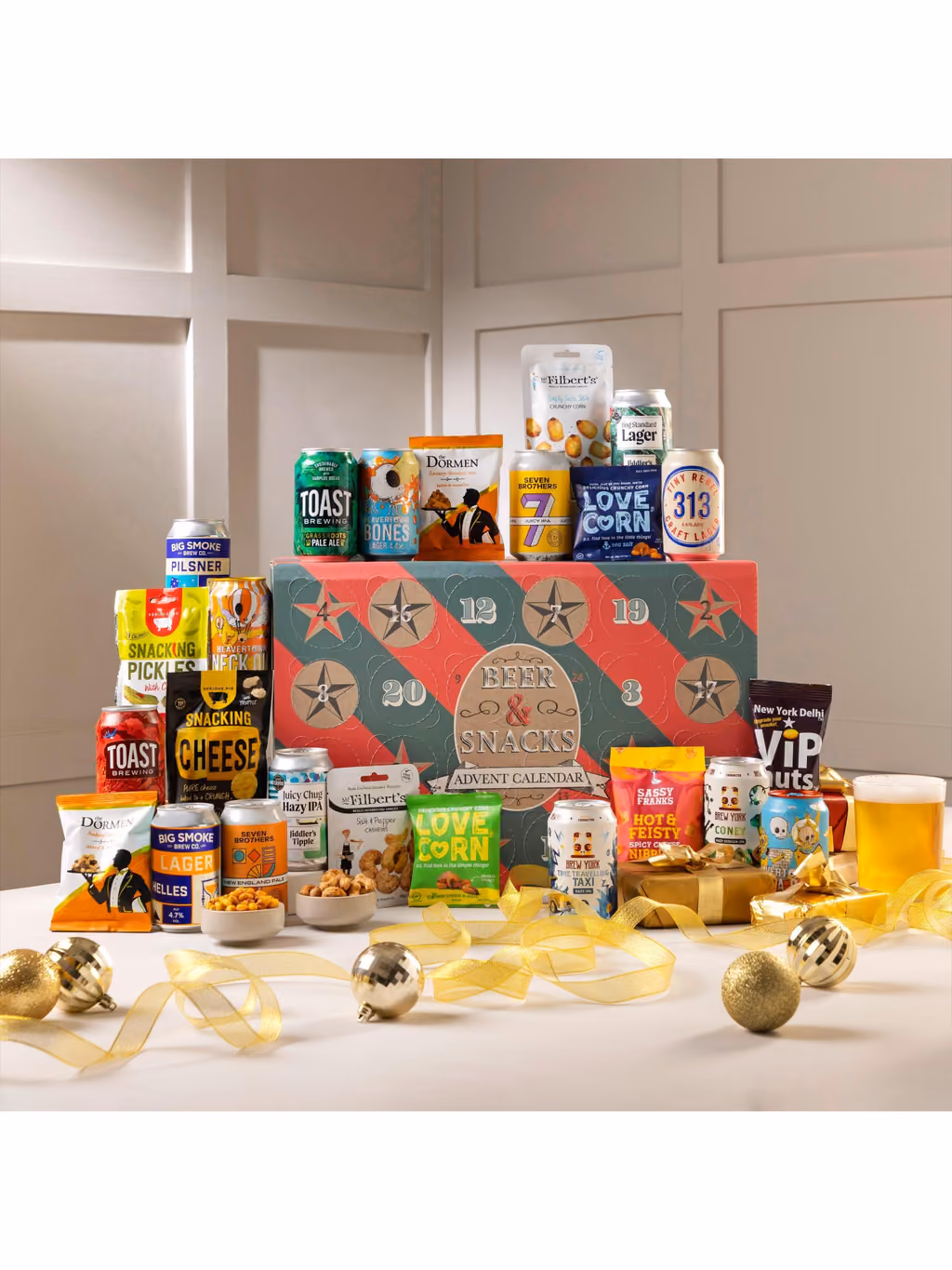 The box on a table with beers and snacks stacked on top