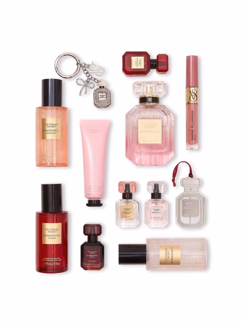 All twelve pieces laid out: the 50 ml bottle, four minis, three mists, gloss, hand cream, keychain and ornament