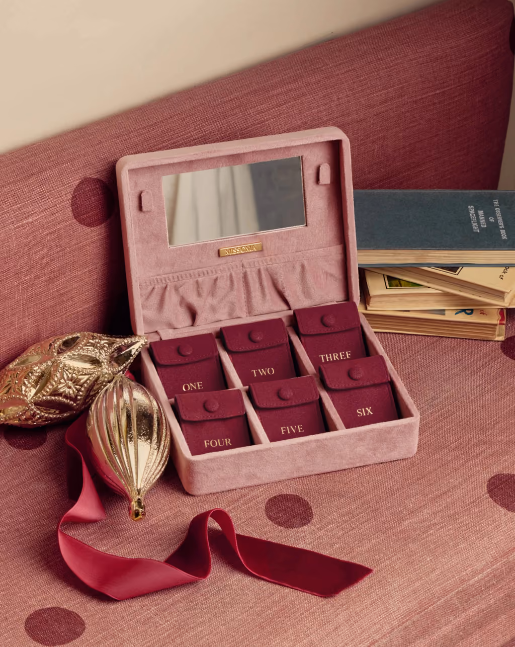 The velvet Missoma box open, its six numbered compartments and mirror lid showing