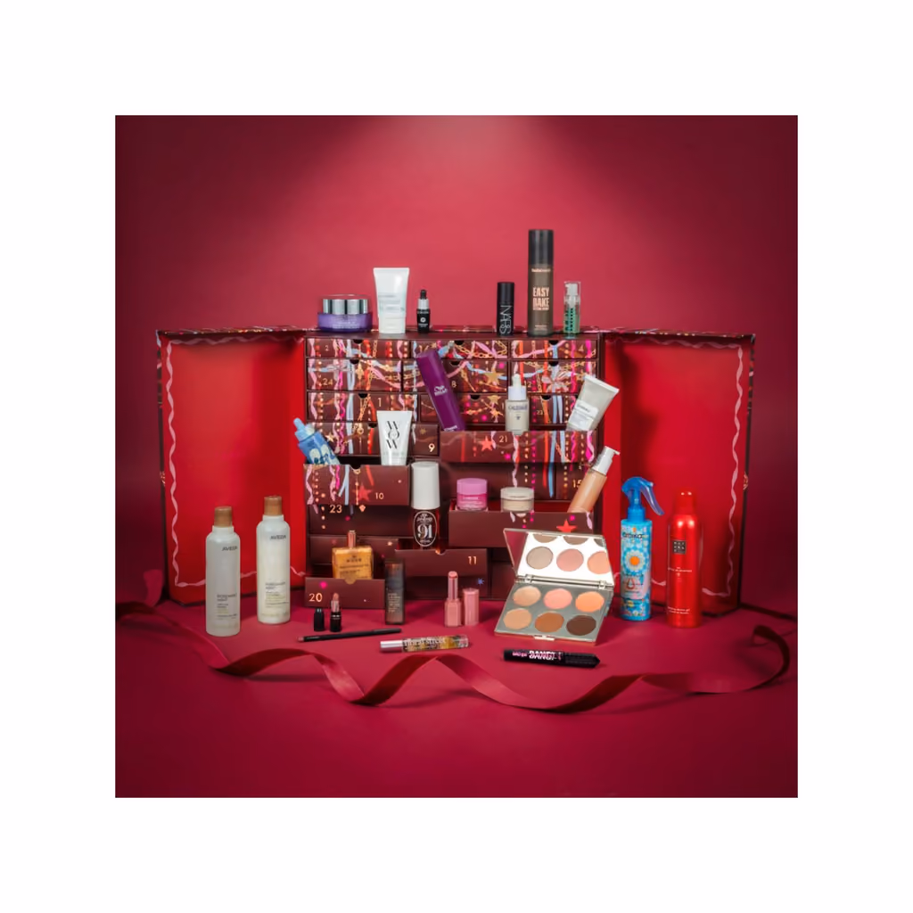The 24 Days of Luxe box on a red set with the 27 products in front of it