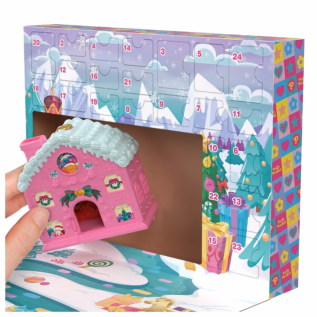 A hand lifting the pink gingerbread house compact out of the box's central window