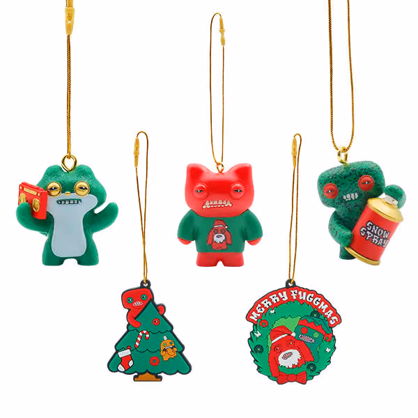 Five of the pieces on gold hanging loops: a green Fuggler with snow spray, a red one in a sweater, a green one with a wreath, a Christmas tree and a Merry Fuggmas wreath