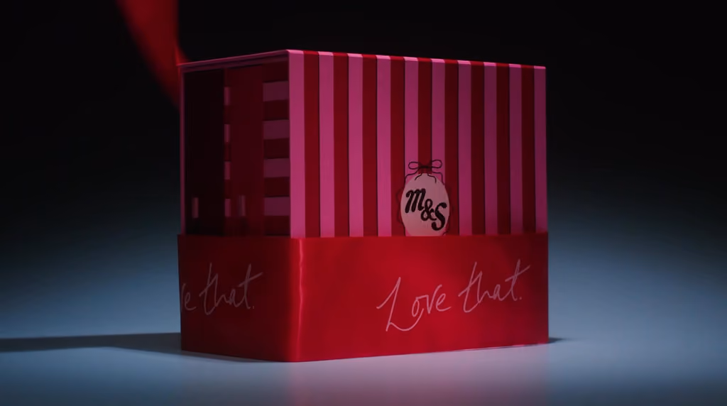 The lid lifting off the striped M&S box in the launch film