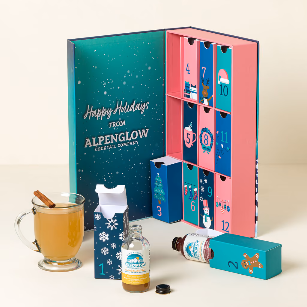 The box open on its numbered drawers, a hot toddy and two bottles in front
