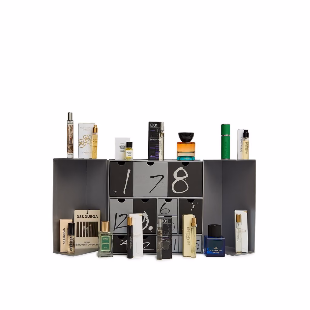 The open drawers with the twelve fragrances on and in front of the box