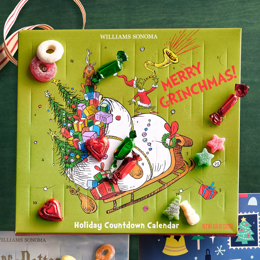 The Grinch x Williams Sonoma advent calendar with its caramels and gummies laid out