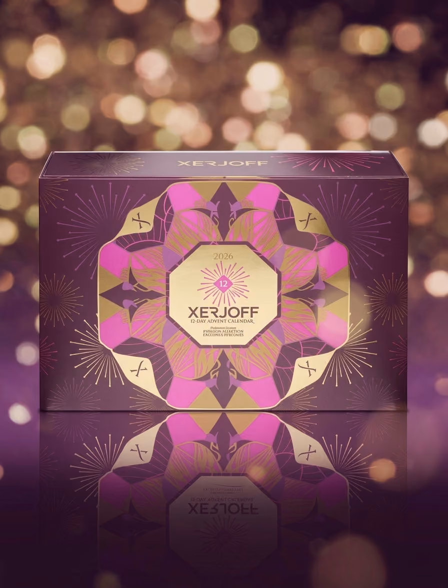 The Xerjoff 12-day box closed, purple and gold, on a background of gold lights