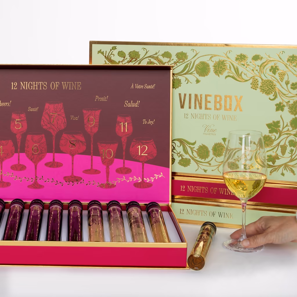 Both boxes, one open to show its twelve vials beside a glass of white