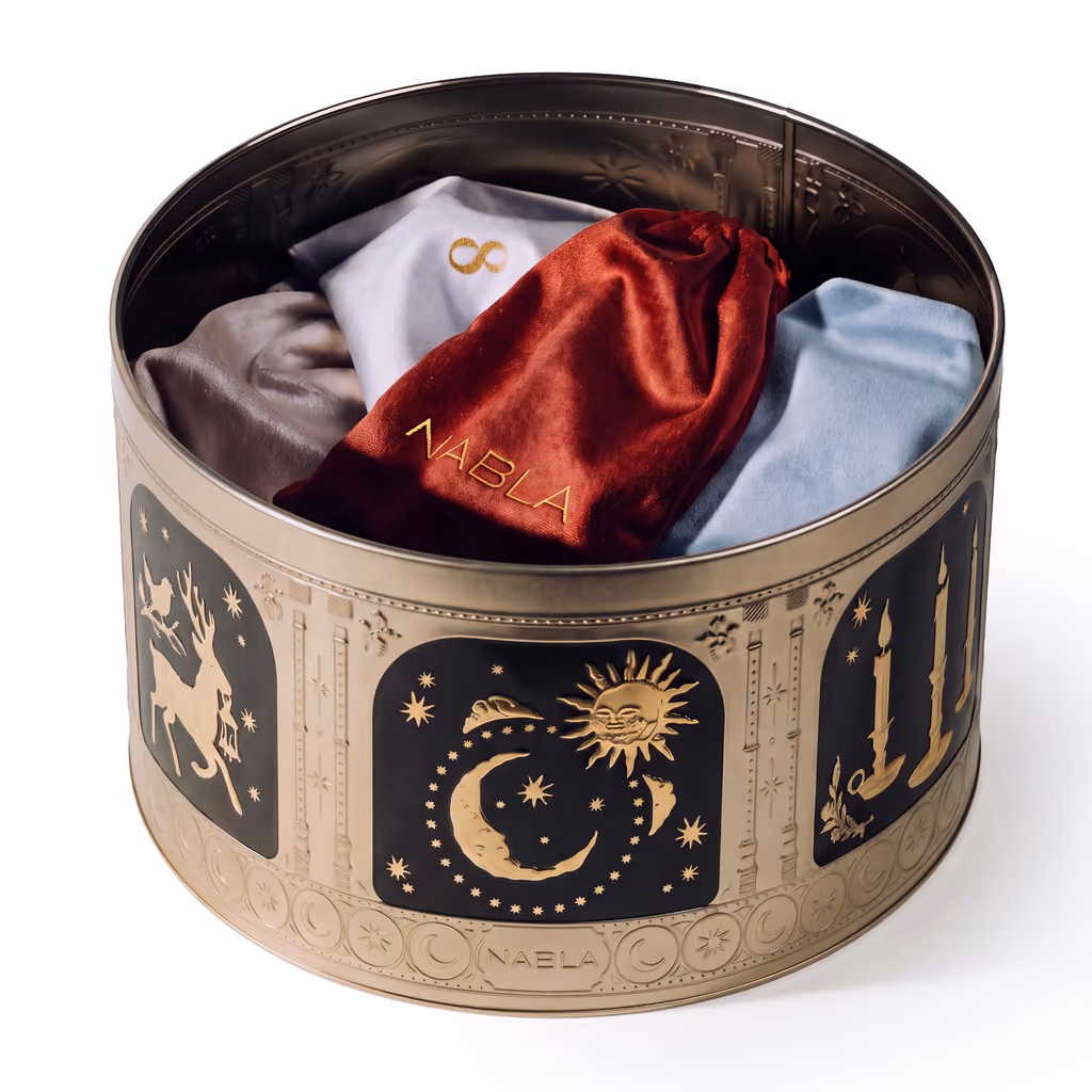 The open tin packed with coloured velvet pouches