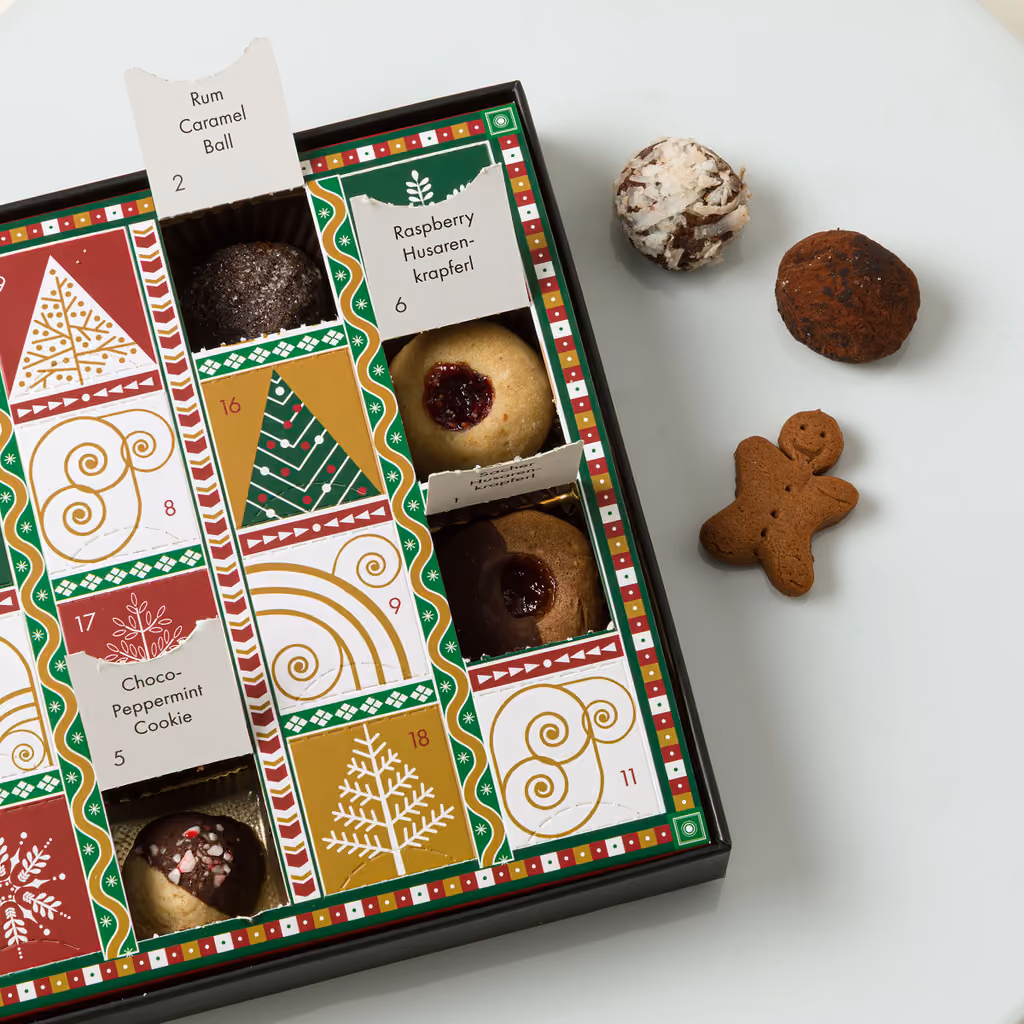 Close-up of opened windows showing a jam thumbprint and chocolate cookies
