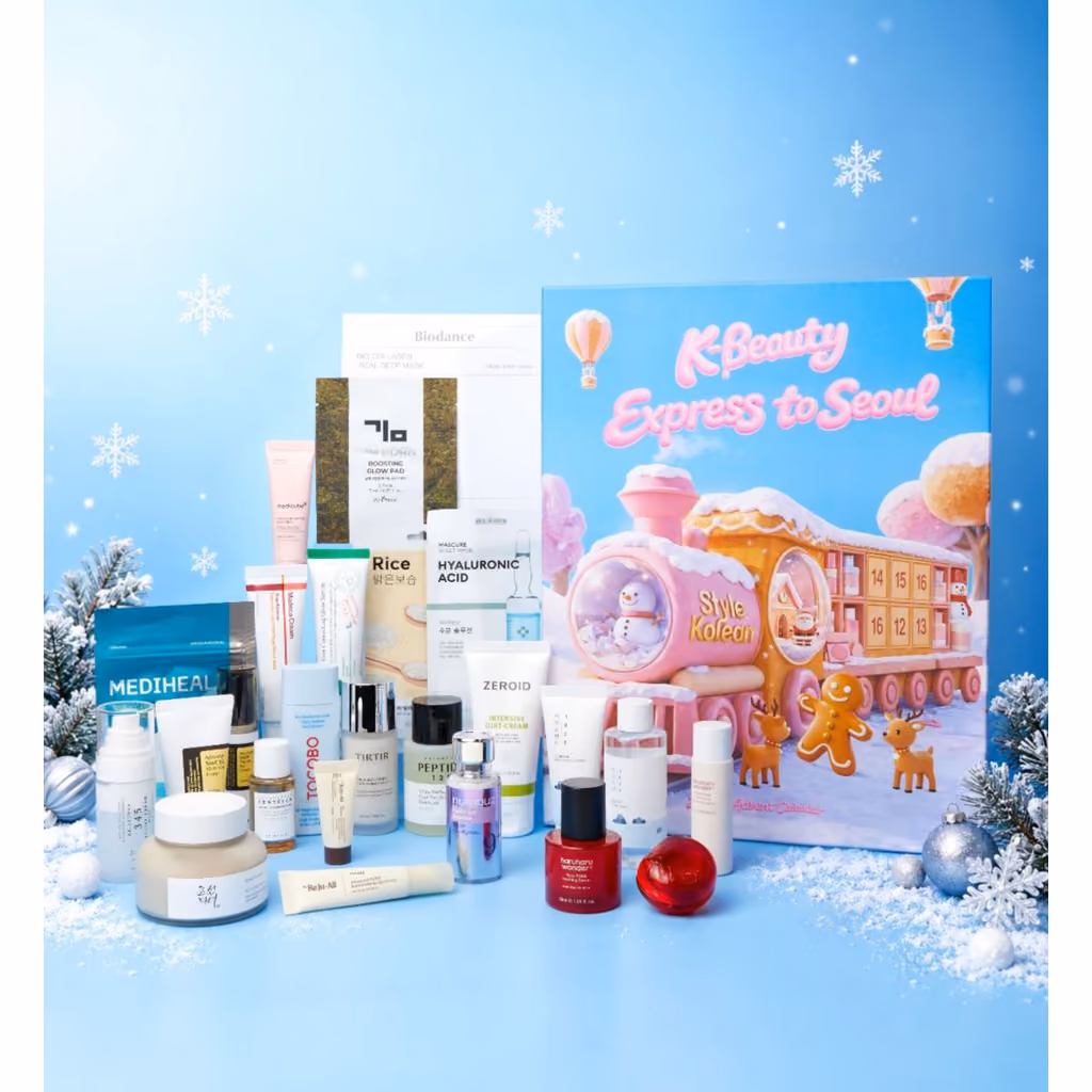 The skincare, masks and tubes stood in front of the pink train box on a snowy blue set