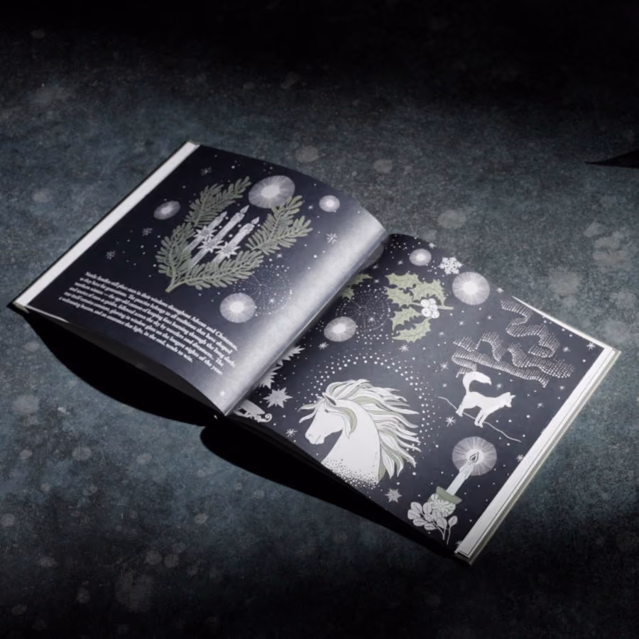 The illustrated storybook of Nordic tales open at a page with a unicorn