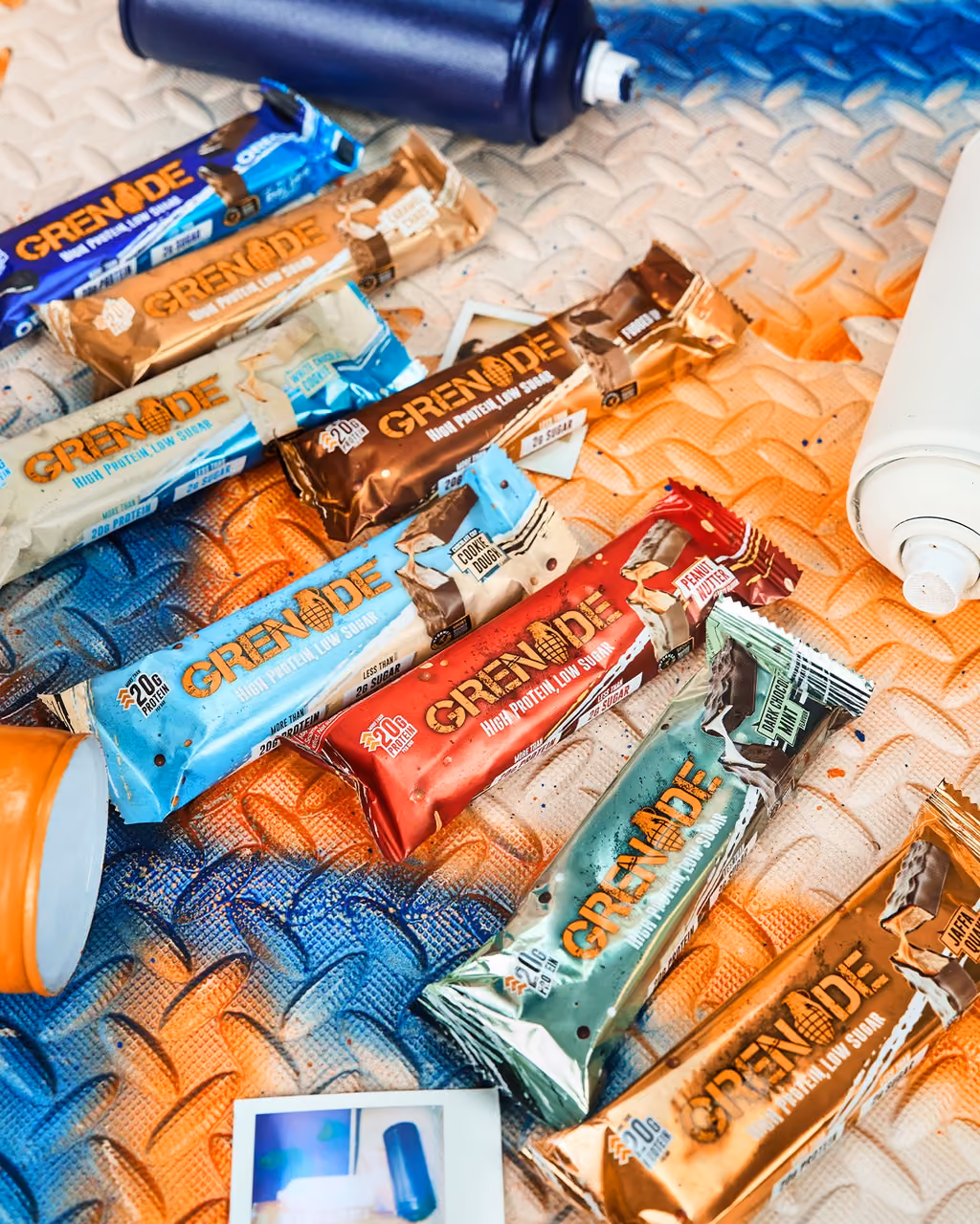 Grenade bars of every flavour scattered on a tread plate floor