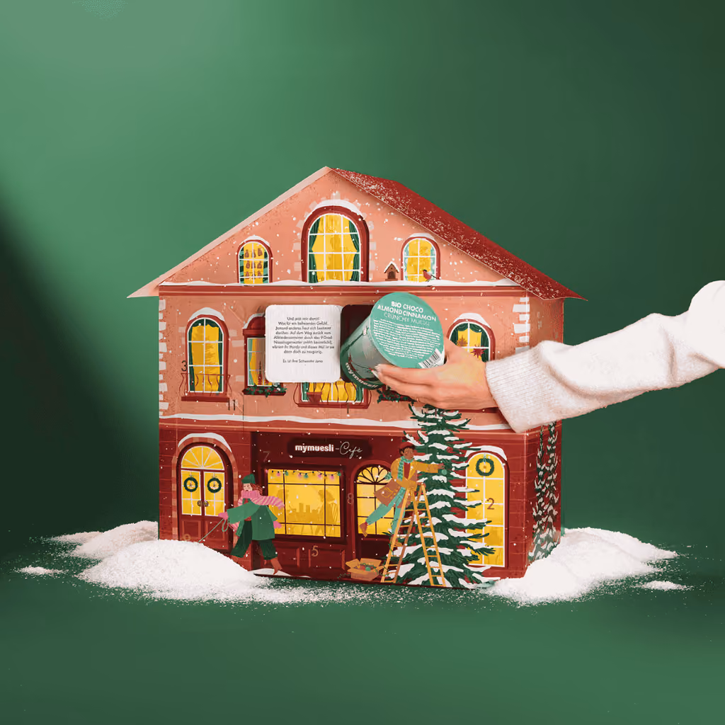 A portion cup being taken from the mymuesli 2026 advent calendar