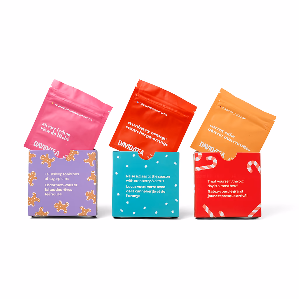 Loose-leaf tea pouches laid out beside the open box