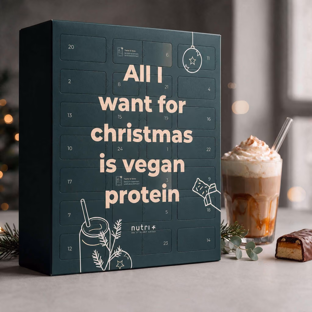 The nutri+ calendar on a table beside a protein shake and a bar