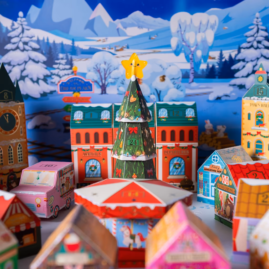 The village square with the star-topped tree under the mountain backdrop