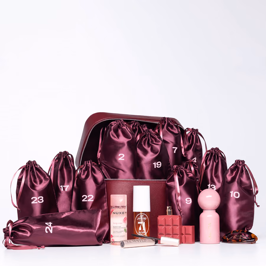 Numbered satin pouches spilling from the case with a few products among them