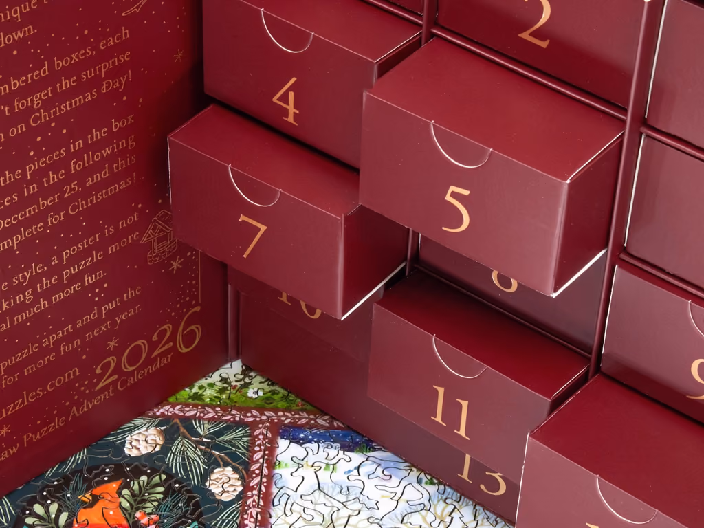Numbered drawers of the box above a corner of the assembled puzzle