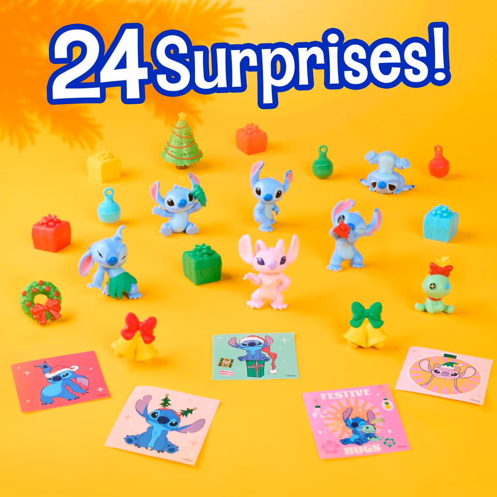 All 24 pieces laid out on yellow: figures, presents, wreaths and stickers