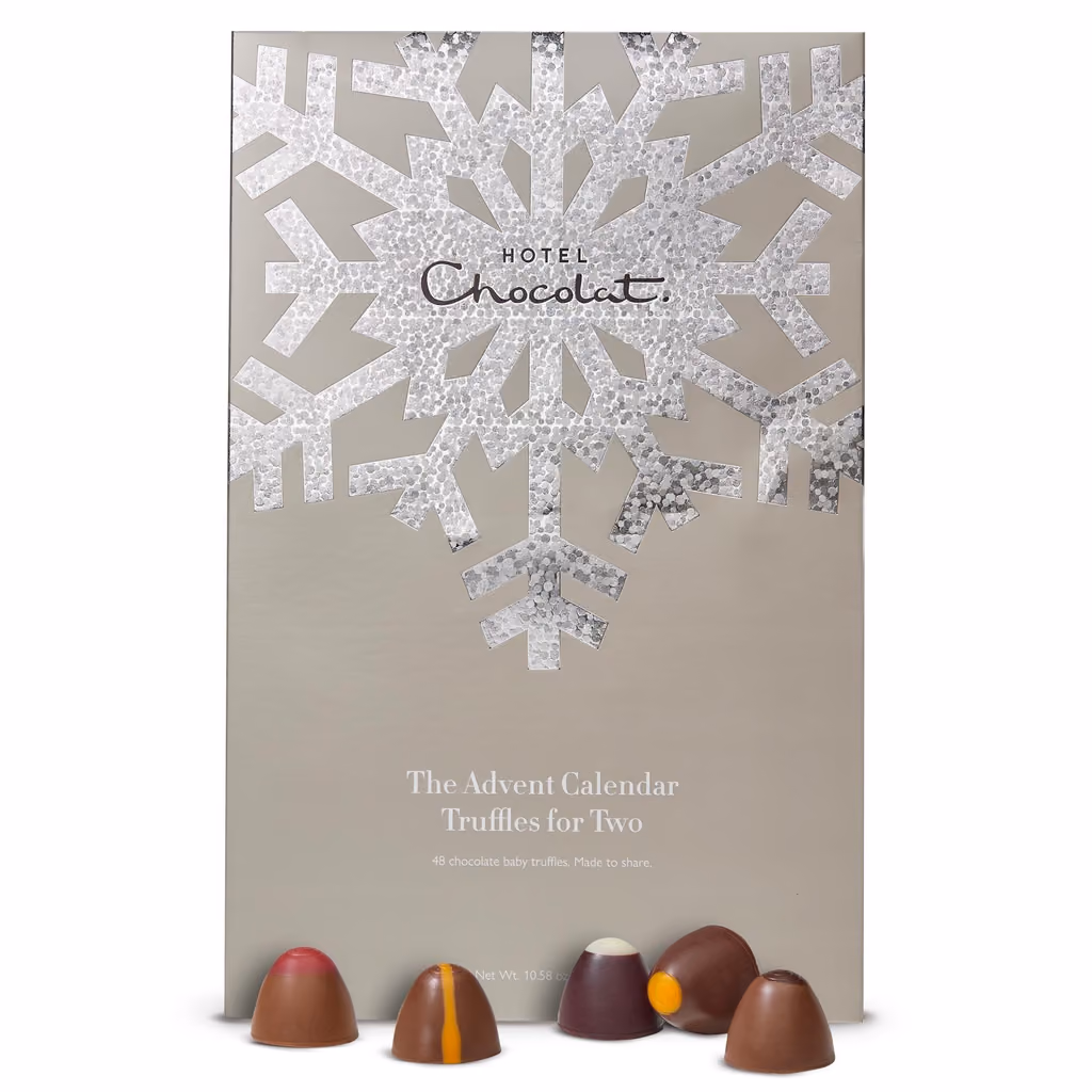 The closed box with chocolates in front of it