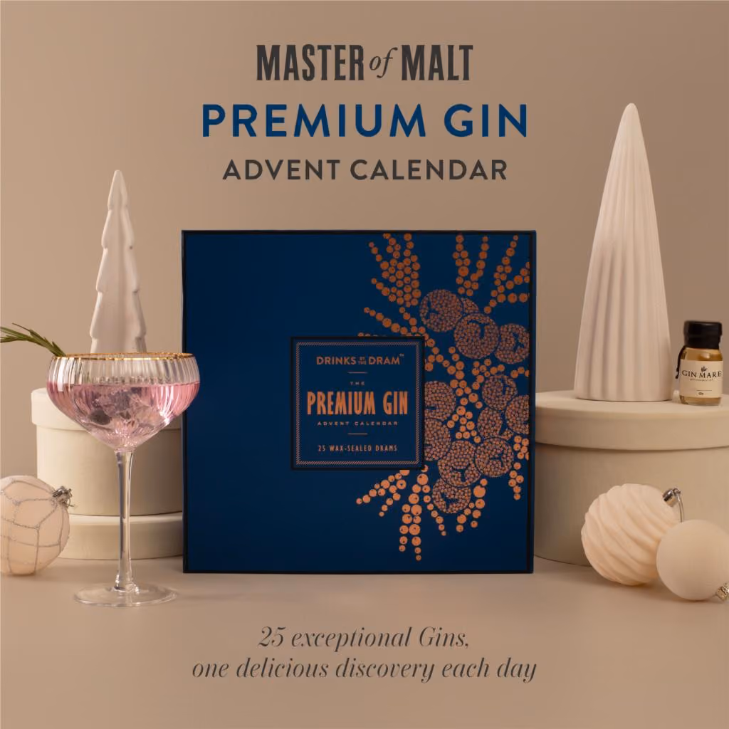 The navy box with copper juniper on a beige set beside a pink gin glass