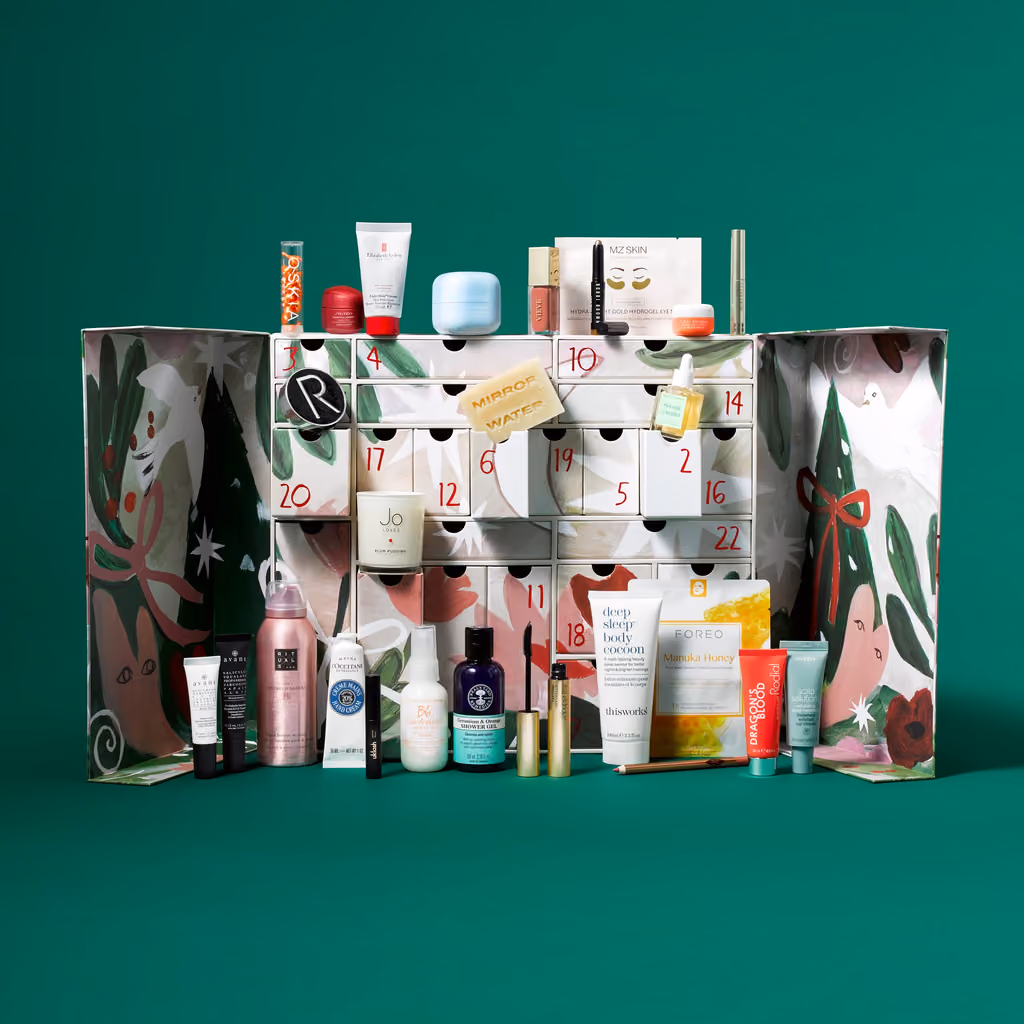 The YOU Beauty 2026 calendar open, its 24 numbered drawers with the 26 products arranged on and around them
