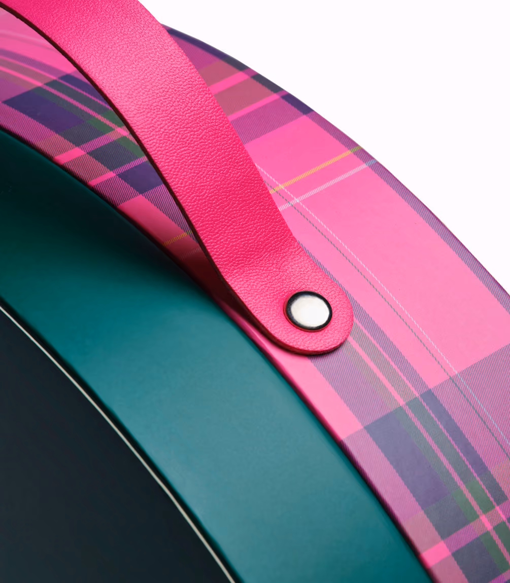 The pink strap and rivet on the green box