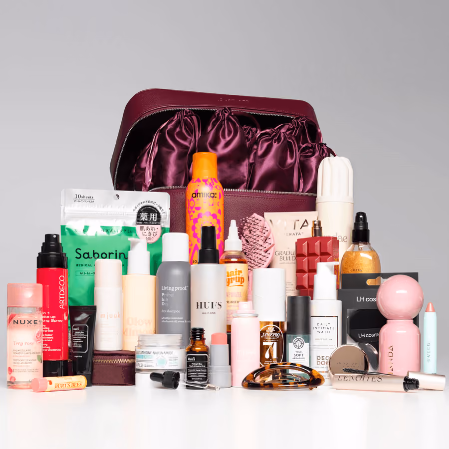 The burgundy case open with all the products lined up in front of it