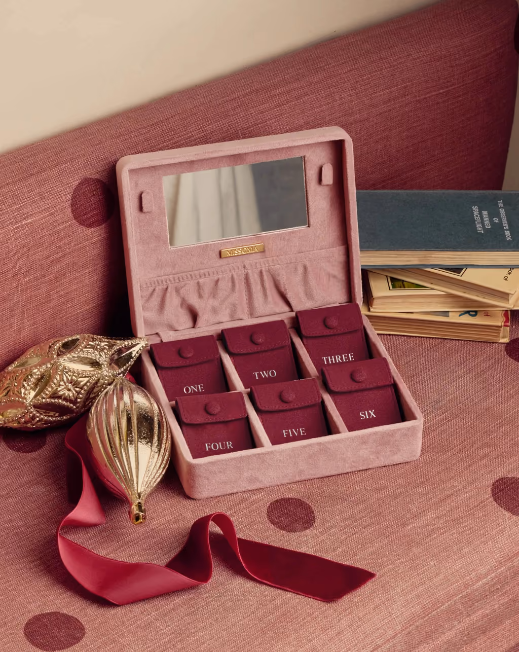 The velvet Missoma box open, its six numbered compartments and mirror lid showing