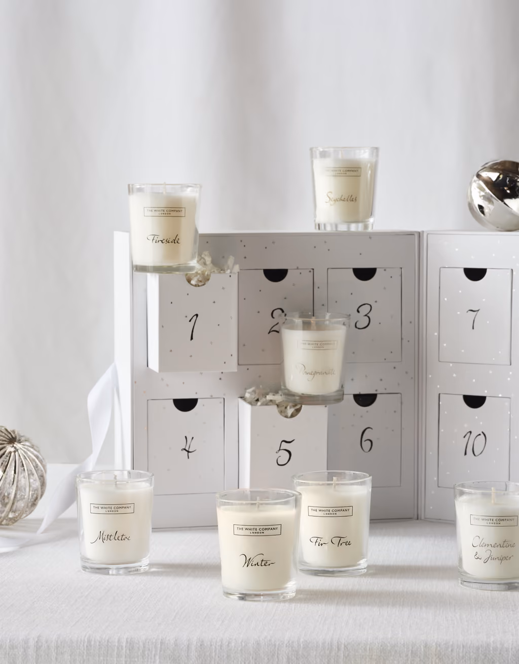 Close view of the numbered drawers with Fireside, Pomegranate, Winter and other votives in front