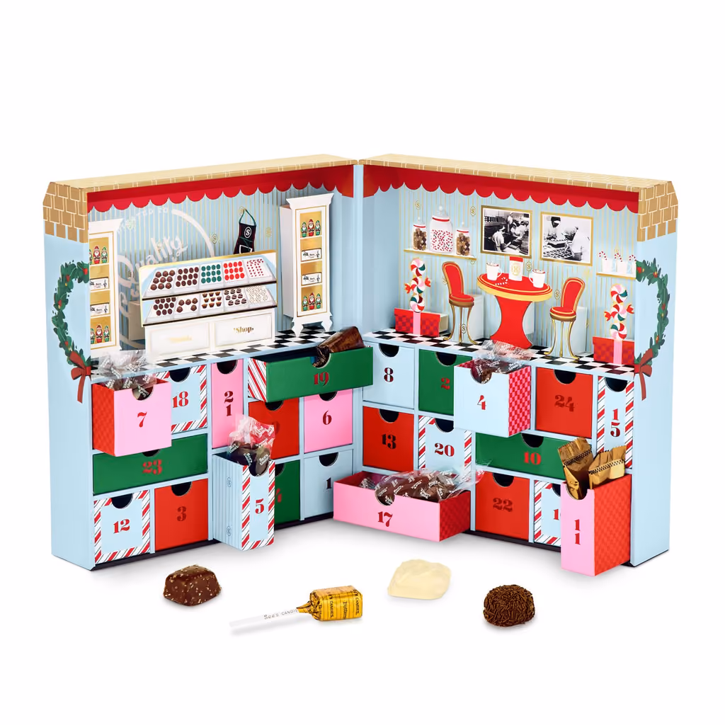 The shop-front box opened like a book onto 24 numbered drawers, with a truffle, a lollypop and two chocolates in front