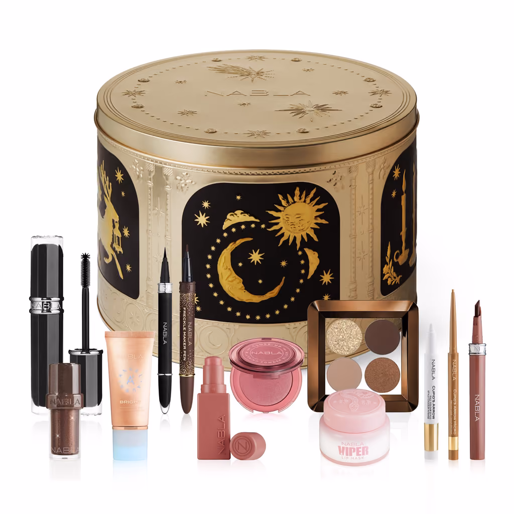 The gold tin with the sixteen make-up products laid out in front of it