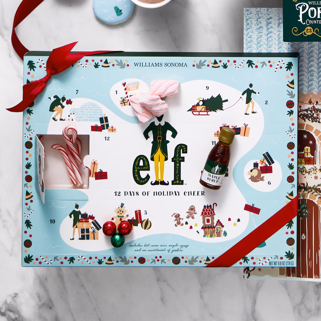 The Elf x Williams Sonoma advent calendar with its sweets and a red ribbon