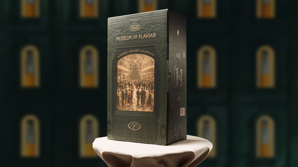 The Museum of Flaviar whiskey advent calendar 2026 on a plinth in a gallery of lit alcoves