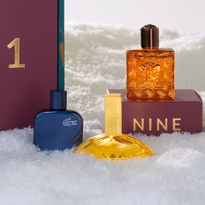 Blue, gold and orange fragrance minis in snow beside door nine