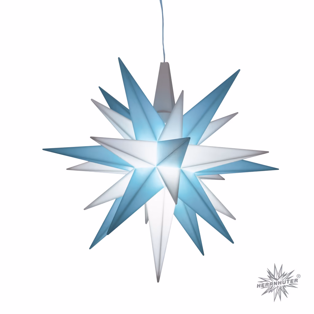 The finished Herrnhuter A1e star in turquoise and white, lit, on a white background