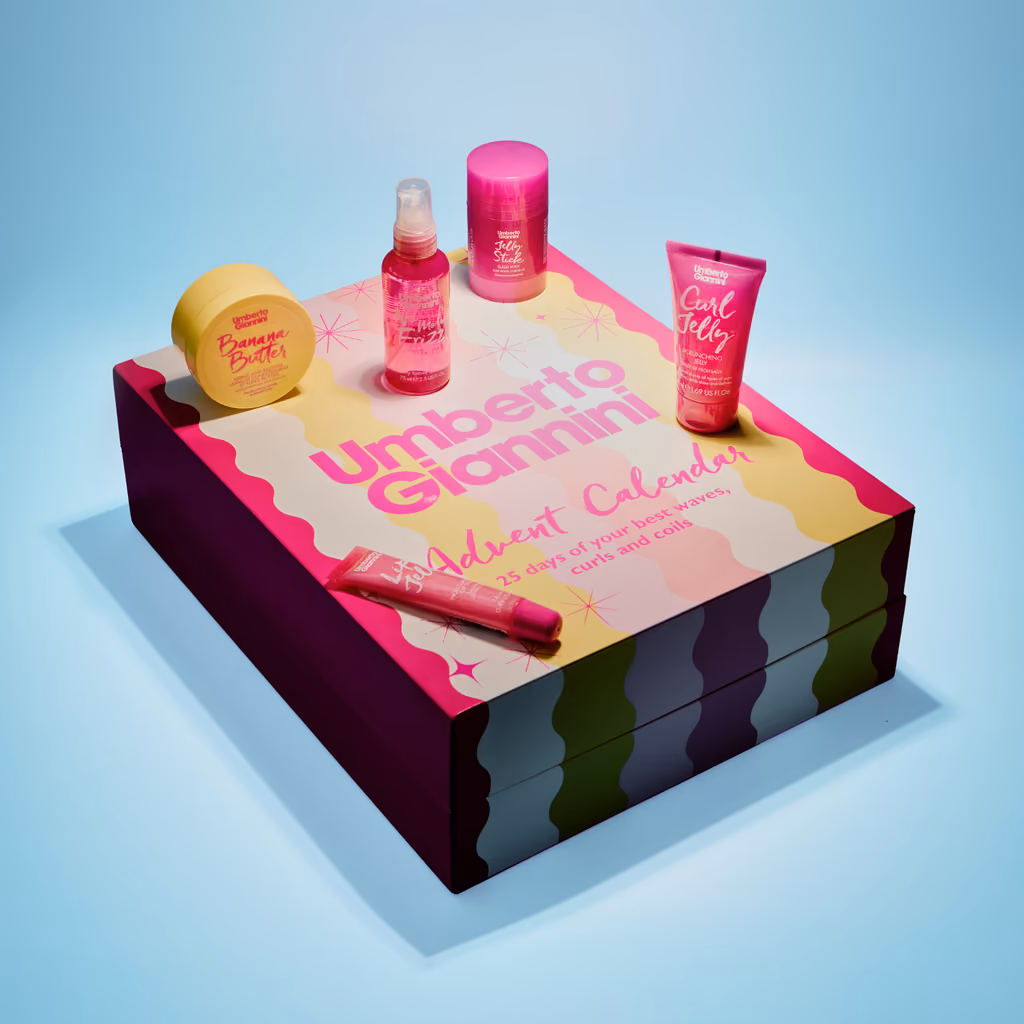 The closed Curlcare 2026 box, its lid reading "25 days of your best waves, curls and coils", with Banana Butter, No More Fizz, a Jelly Stick, Curl Jelly and a lip jelly arranged on top