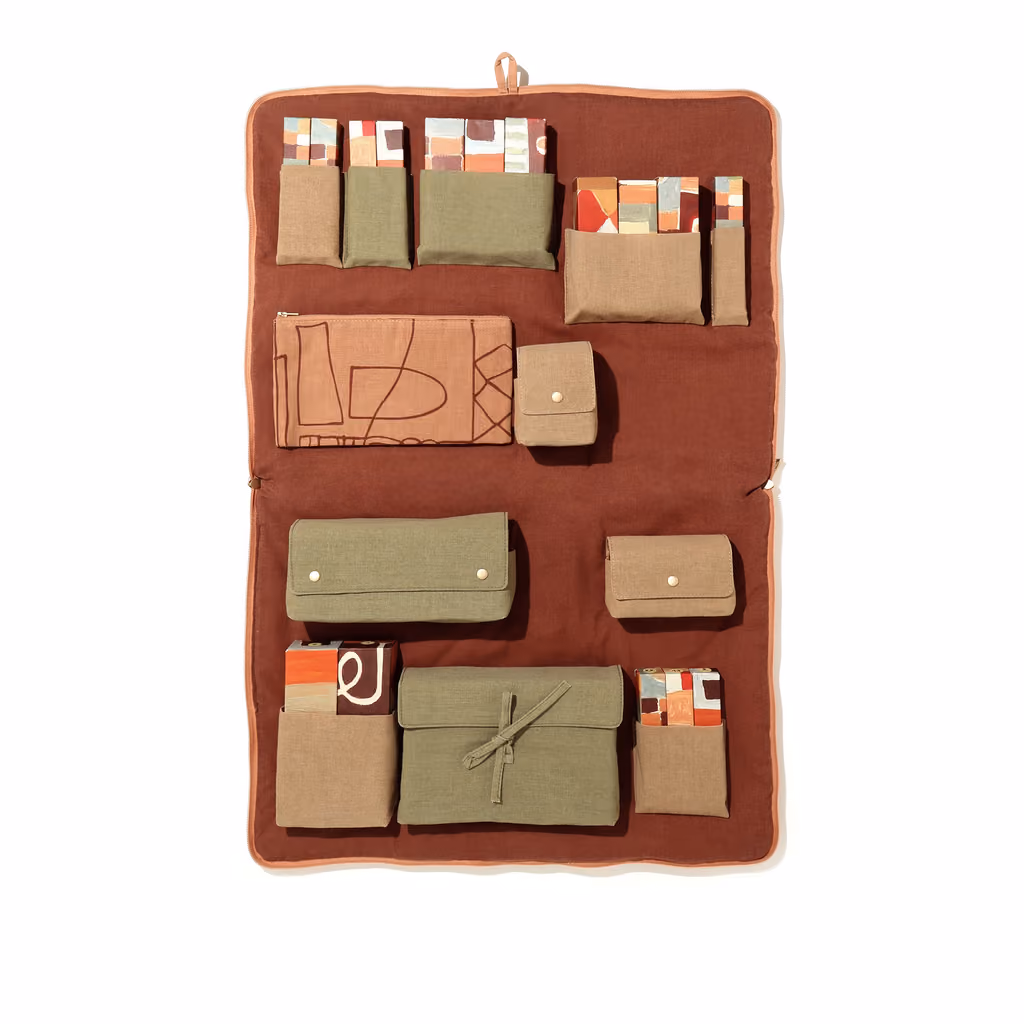 The LRNCE x Oh My Cream 2026 case open, showing the 25 numbered compartments in their Moroccan-patterned sleeve