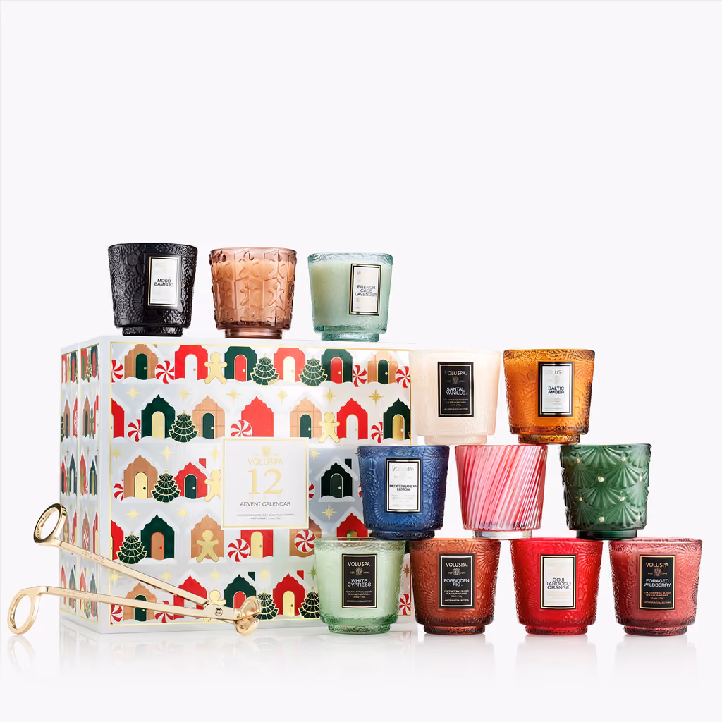 The Voluspa 12 Day Holiday Village box with its 12 candles and the wick trimmer in front