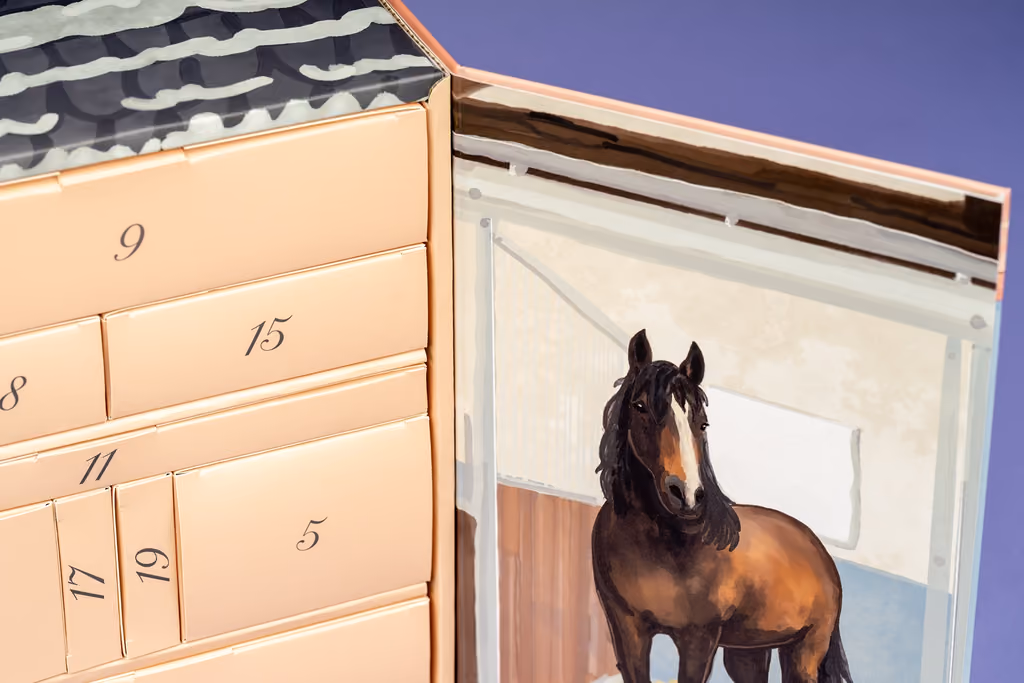 Close-up of the numbered drawers beside a painted bay horse