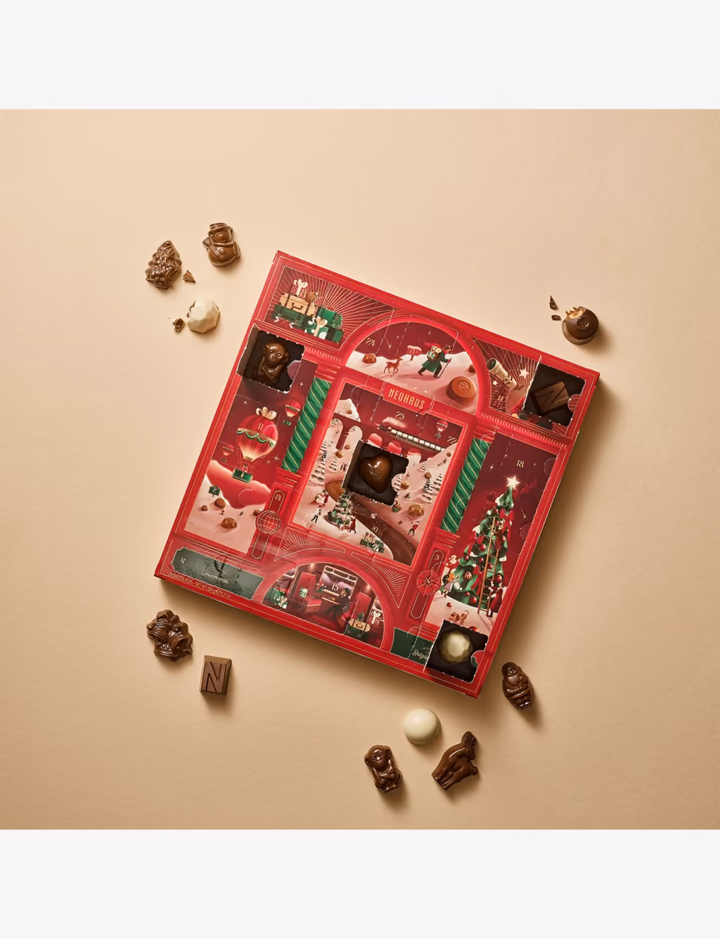 The calendar lying flat with pralines and figurines scattered around it