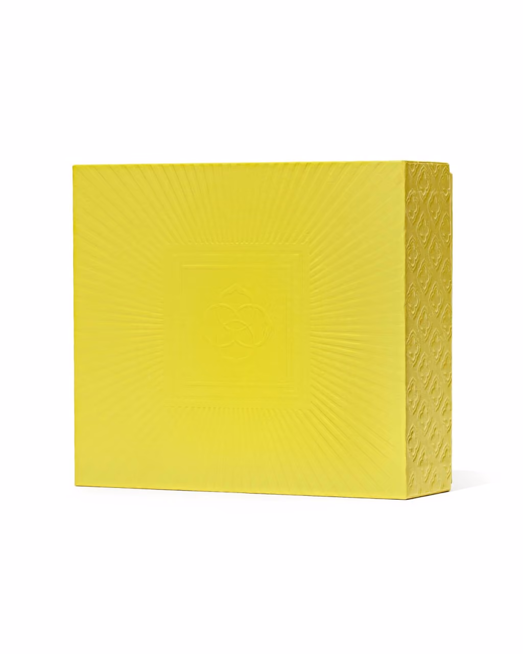 The closed chartreuse case with its embossed sunburst lid