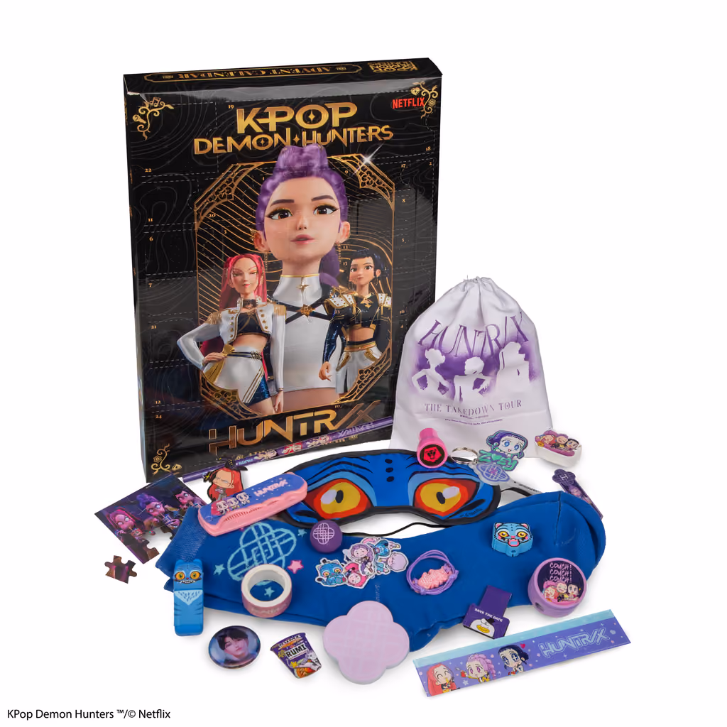 The KPop Demon Hunters 2026 box beside its 24 gifts, among them a HUNTR/X drawstring bag, a Derpy sleep mask, a beanie, socks, a keyring, pins, stickers, washi tape and a ruler