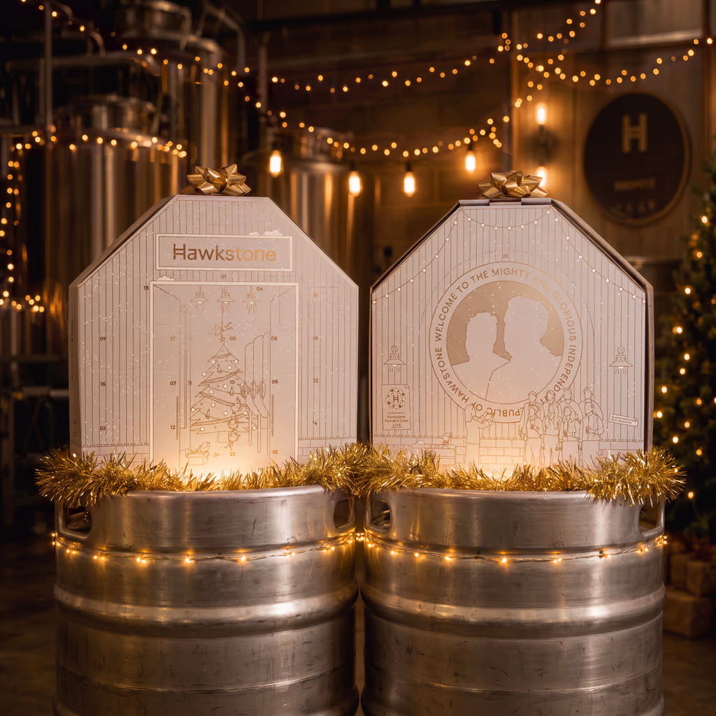 Two of the brewery-shaped boxes standing on beer kegs in the brewery
