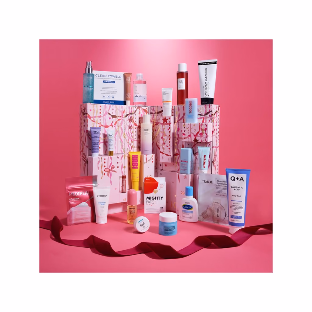 The 24 Days of Skin box on a red set with its 24 products around it