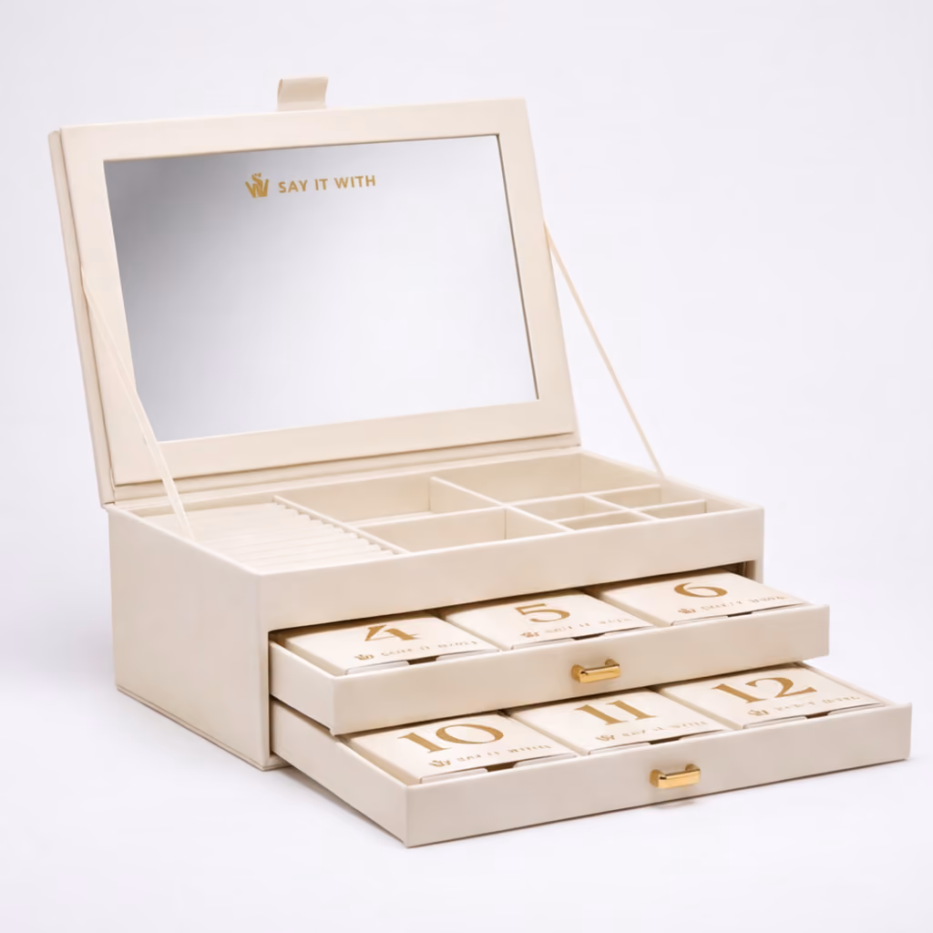 The cream box open with its mirror lid up and both numbered drawers pulled out