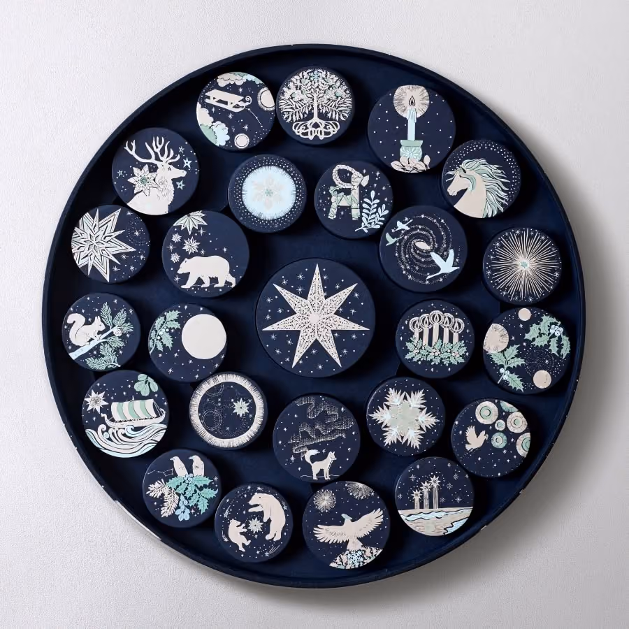 The round Dandelion Chocolate 2026 calendar open, its 25 illustrated ornament boxes in their tray
