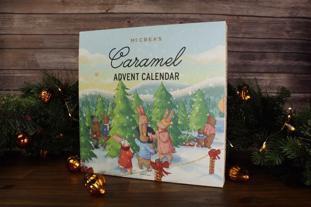 The Cheerful Tree Farm box standing among evergreen branches and lights